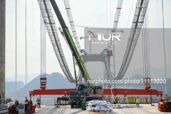 Workers are working at the construction site of Jinzhou Bridge in Xingyi, China, on March 31, 2024. 