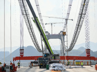 Workers are working at the construction site of Jinzhou Bridge in Xingyi, China, on March 31, 2024. (