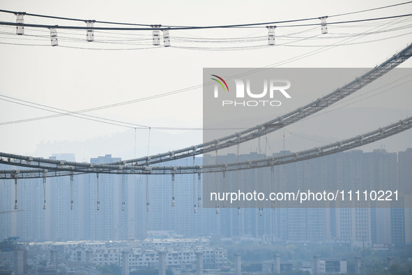 Workers are working at the construction site of Jinzhou Bridge in Xingyi, China, on March 31, 2024. 