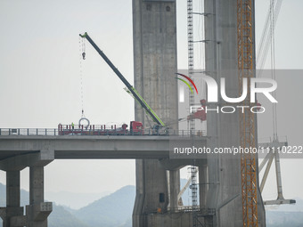 Workers are working at the construction site of Jinzhou Bridge in Xingyi, China, on March 31, 2024. (