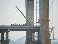 Workers are working at the construction site of Jinzhou Bridge in Xingyi, China, on March 31, 2024. (