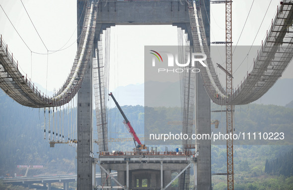 Workers are working at the construction site of Jinzhou Bridge in Xingyi, China, on March 31, 2024. 