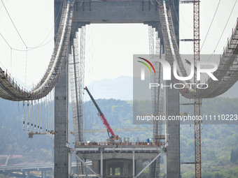 Workers are working at the construction site of Jinzhou Bridge in Xingyi, China, on March 31, 2024. (