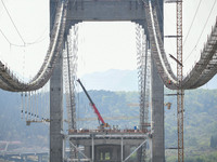 Workers are working at the construction site of Jinzhou Bridge in Xingyi, China, on March 31, 2024. (