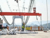 Workers are working at the construction site of Jinzhou Bridge in Xingyi, China, on March 31, 2024. (