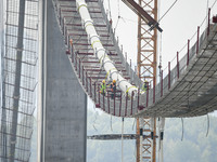 Workers are working at the construction site of Jinzhou Bridge in Xingyi, China, on March 31, 2024. (