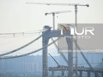 Workers are working at the construction site of Jinzhou Bridge in Xingyi, China, on March 31, 2024. (