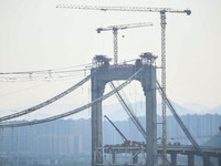 Workers are working at the construction site of Jinzhou Bridge in Xingyi, China, on March 31, 2024. (