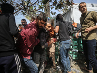 Paramedics are transporting a wounded Palestinian at the Al-Aqsa Martyrs Hospital in Deir al-Balah in the central Gaza Strip, following an I...