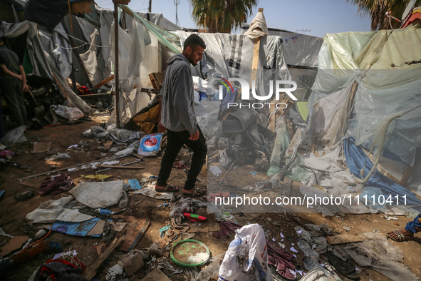 Palestinians are checking the damage at a makeshift camp for displaced people in front of the Al-Aqsa Martyrs Hospital in Deir al-Balah in t...