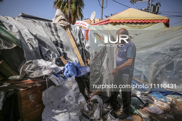 Palestinians are checking the damage at a makeshift camp for displaced people in front of the Al-Aqsa Martyrs Hospital in Deir al-Balah in t...