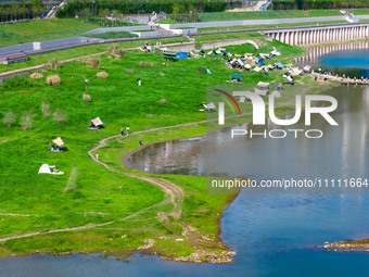 Tourists are camping and playing on the river beach as the water levels of the Yangtze and Jialing rivers continue to fall in Chongqing, Chi...