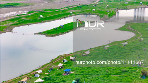 Tourists are camping and playing on the river beach as the water levels of the Yangtze and Jialing rivers continue to fall in Chongqing, Chi...