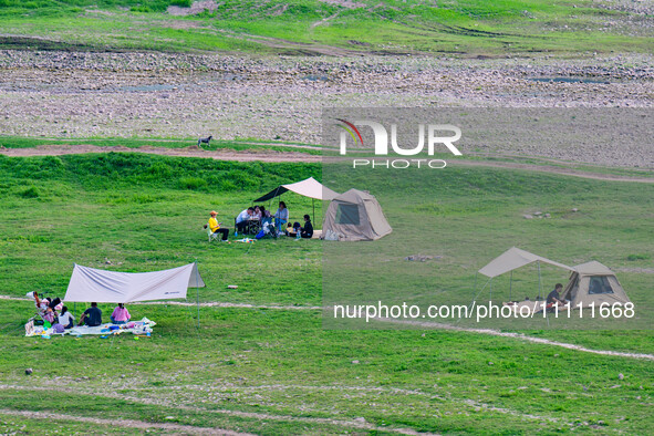 Tourists are camping and playing on the river beach as the water levels of the Yangtze and Jialing rivers continue to fall in Chongqing, Chi...