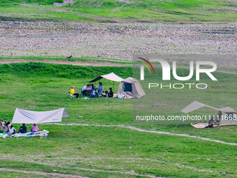 Tourists are camping and playing on the river beach as the water levels of the Yangtze and Jialing rivers continue to fall in Chongqing, Chi...