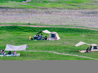 Tourists are camping and playing on the river beach as the water levels of the Yangtze and Jialing rivers continue to fall in Chongqing, Chi...