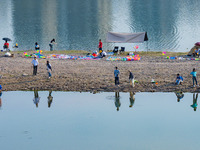 Tourists are camping and playing on the river beach as the water levels of the Yangtze and Jialing rivers continue to fall in Chongqing, Chi...