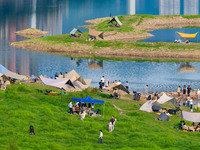 Tourists are camping and playing on the river beach as the water levels of the Yangtze and Jialing rivers continue to fall in Chongqing, Chi...