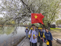 Primary school students are participating in a research activity amid blooming flowers at the Hongze Lake Wetland scenic spot in Sihong Coun...