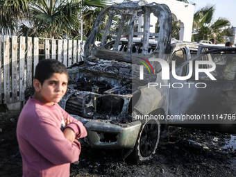 Palestinians are standing next to a vehicle in Deir Al-Balah, in the central Gaza Strip, on April 2, 2024, where employees from the World Ce...