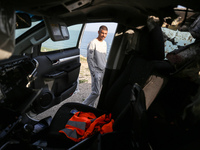 Palestinians are standing next to a vehicle in Deir Al-Balah, in the central Gaza Strip, on April 2, 2024, where employees from the World Ce...