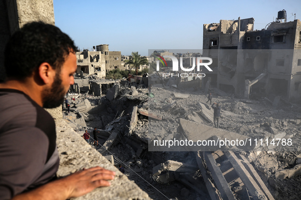 Palestinians are inspecting the damage in the rubble of the Al-Bashir mosque following Israeli bombardment in Deir al-Balah, central Gaza St...