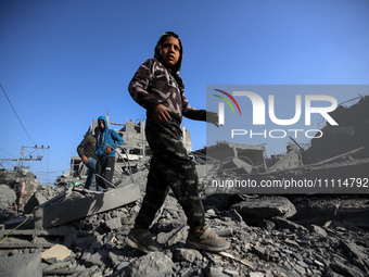 Palestinians are inspecting the damage in the rubble of the Al-Bashir mosque following Israeli bombardment in Deir al-Balah, central Gaza St...