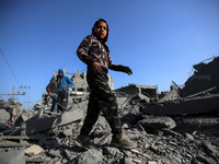 Palestinians are inspecting the damage in the rubble of the Al-Bashir mosque following Israeli bombardment in Deir al-Balah, central Gaza St...