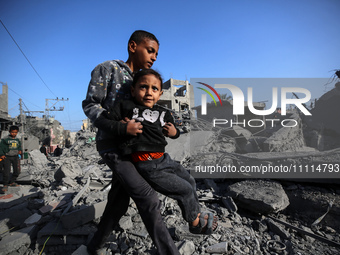 Palestinians are inspecting the damage in the rubble of the Al-Bashir mosque following Israeli bombardment in Deir al-Balah, central Gaza St...