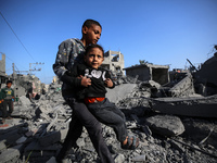 Palestinians are inspecting the damage in the rubble of the Al-Bashir mosque following Israeli bombardment in Deir al-Balah, central Gaza St...