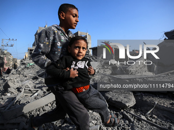 Palestinians are inspecting the damage in the rubble of the Al-Bashir mosque following Israeli bombardment in Deir al-Balah, central Gaza St...