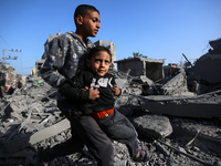 Palestinians are inspecting the damage in the rubble of the Al-Bashir mosque following Israeli bombardment in Deir al-Balah, central Gaza St...