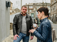 Oleksandr Andrieiev, the Director of the Department of Capital Construction communal enterprise, is speaking to a journalist near a new modu...