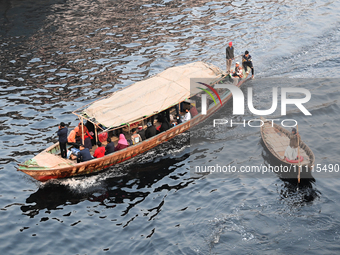 Bangladeshi People Cross On Boat Over The Pitch Black Water Of The Polluted Buriganga River In Dhaka, Bangladesh, On April 2, 2024. Banglade...