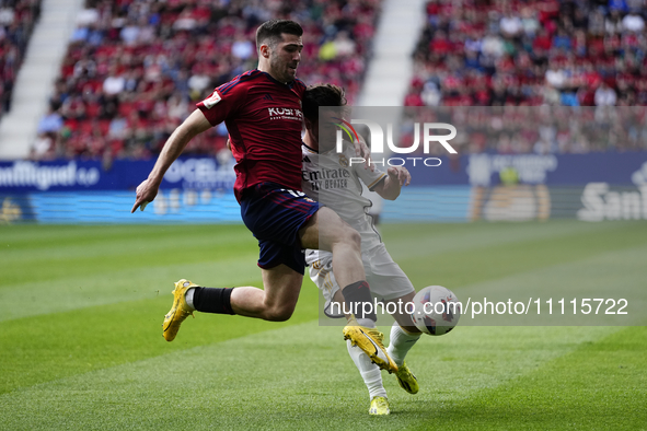 Jesus Areso right-back of Osasuna and Spain and Brahim Diaz attacking midfield of Real Madrid and Spain compete for the ball during the LaLi...