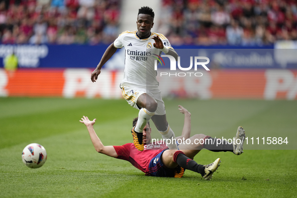 Vinicius Junior left winger of Real Madrid and Brazil and Unai Garcia centre-back of Osasuna and Spain compete for the ball during the LaLig...