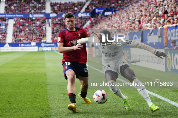 Ferland Mendy left-back of Real Madrid and France and Jesus Areso right-back of Osasuna and Spain compete for the ball during the LaLiga EA...