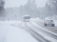 A bus is traveling on a road during a snowfall in Linkoping, Sweden, on April 2, 2024. (