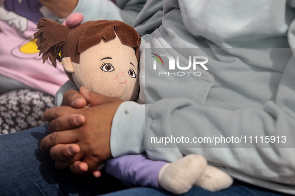 In Ecatepec, Mexico, on April 2, 2024, a child is holding a doll while participating in a cultural activity as part of World Autism Awarenes...