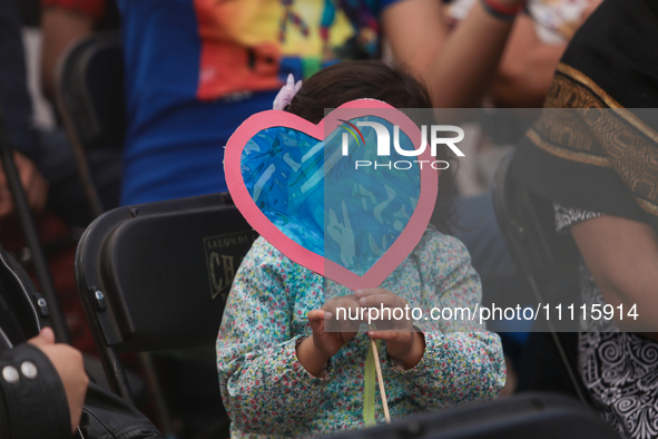 In Ecatepec, Mexico, on April 2, 2024, a child is holding blue hearts made of cellophane paper while participating in a cultural activity as...