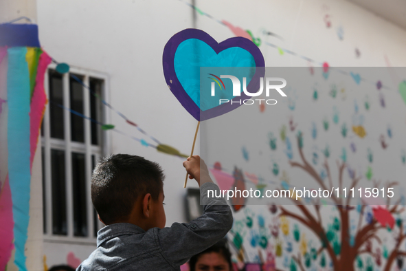 In Ecatepec, Mexico, on April 2, 2024, a child is holding blue hearts made of cellophane paper while participating in a cultural activity as...