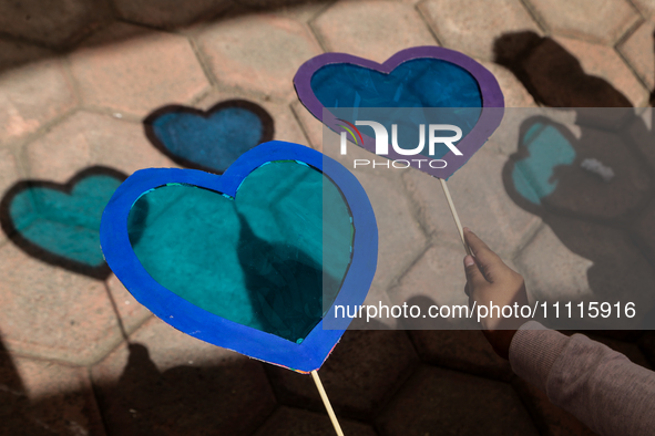 In Ecatepec, Mexico, on April 2, 2024, a child is holding blue hearts made of cellophane paper while participating in a cultural activity as...