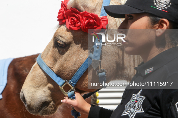 A female police officer is participating in a cultural activity as part of World Autism Awareness Day in Ecatepec, Mexico, on April 2, 2024....