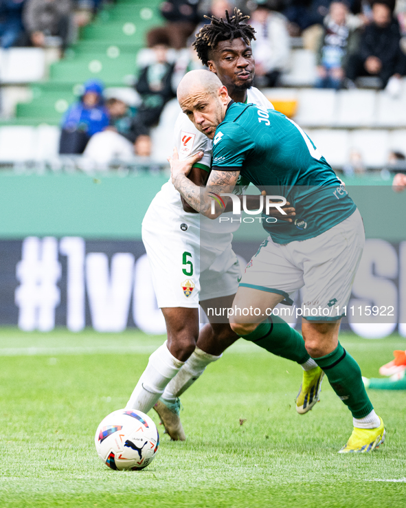 Jon Garcia (R) of Racing de Ferrol is fighting for the ball with John Chetauya (L) of Elche CF during the LaLiga Hypermotion match between R...