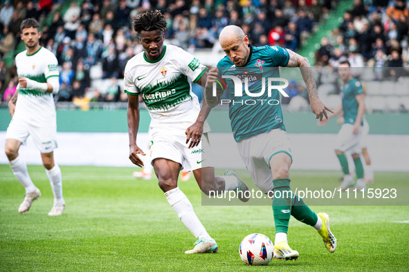 Jon Garcia (R) of Racing de Ferrol is fighting for the ball with John Chetauya (L) of Elche CF during the LaLiga Hypermotion match between R...