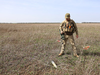 A serviceman with a metal detector is participating in the field tests of the MinesEye unmanned system for the detection of mines and explos...