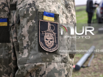 A chevron is being seen on a soldier's uniform during the field tests of the MinesEye unmanned system for the detection of mines and explosi...