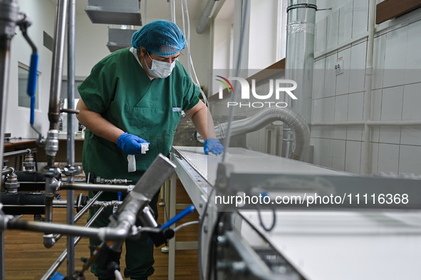 Senior Researcher Nataliia Nosova is disinfecting the surface during the production of medicinal hydrogel dressings for Ukrainian soldiers a...