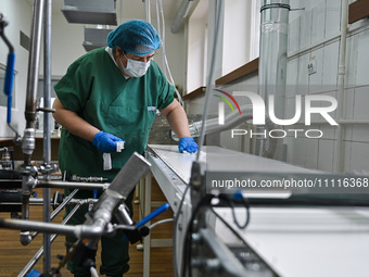 Senior Researcher Nataliia Nosova is disinfecting the surface during the production of medicinal hydrogel dressings for Ukrainian soldiers a...