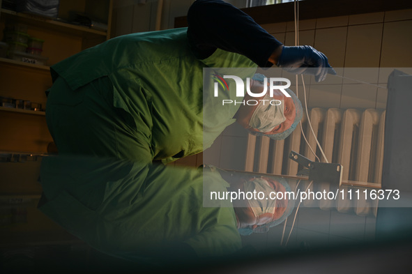 Professor Volodymyr Samaryk, Doctor of Chemical Sciences, is looking into the dehydration furnace during the production of medicinal hydroge...